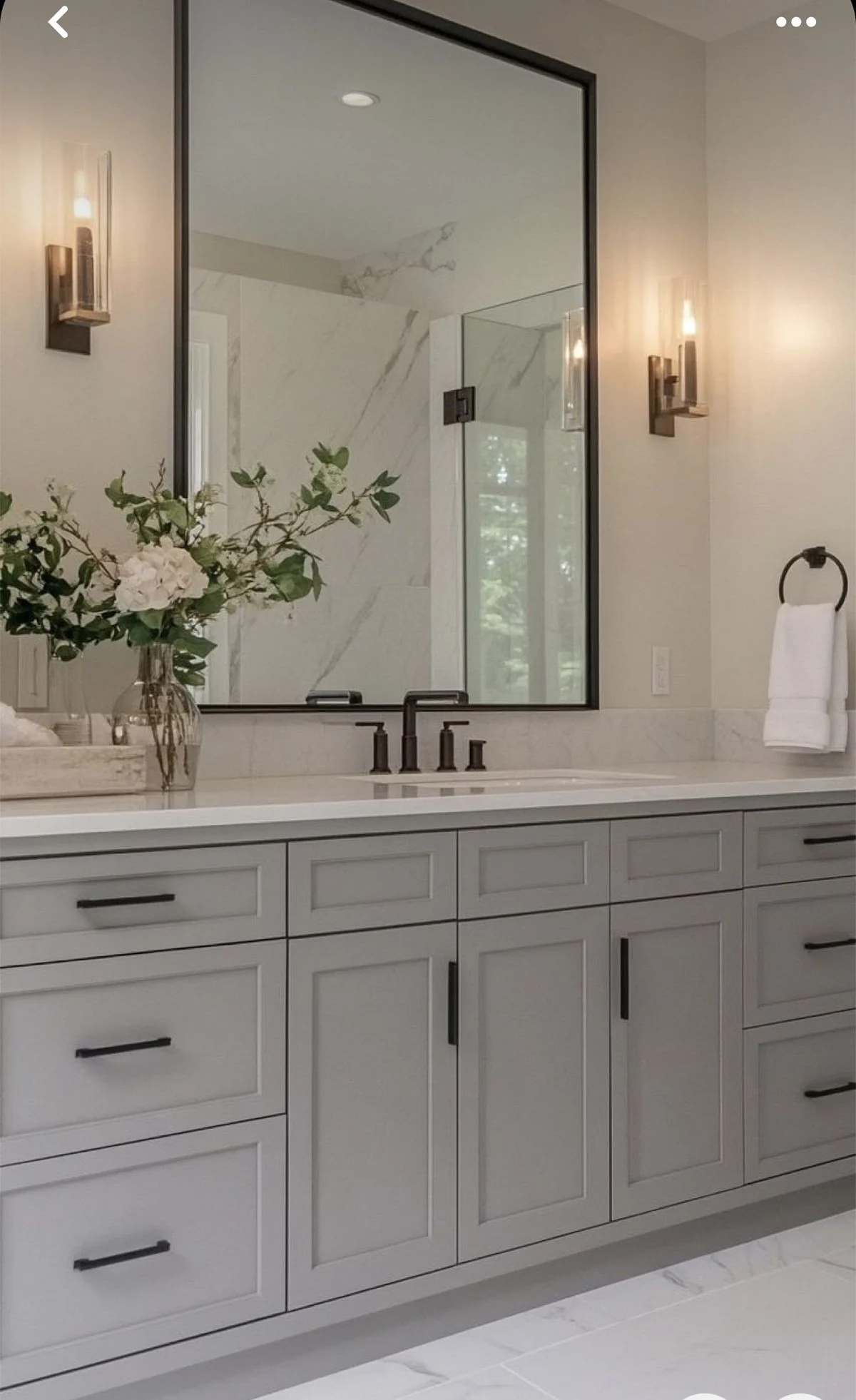 Grey bathroom vanity with stone countertop and two mirrors