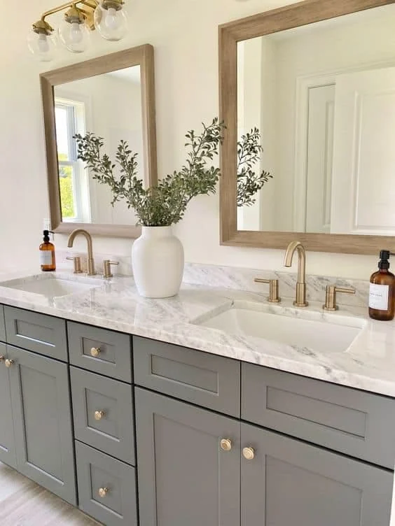 Light bathroom vanity with white countertop and warm accent lighting