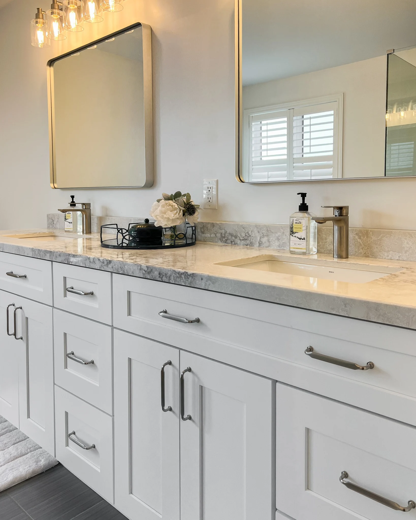 Wood bathroom vanity with light countertop and walk-in shower
