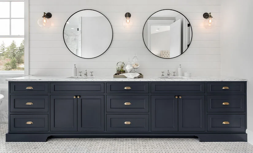 Long dark grey bathroom vanity with twin round mirrors