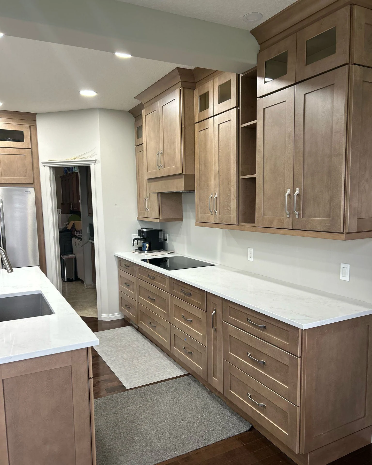 Modern kitchen with white island and tall wood cabinetry