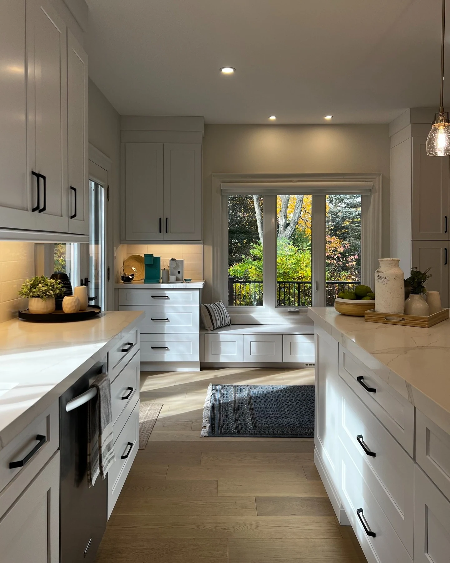 Kitchen with grey cabinets and long island overlooking living space