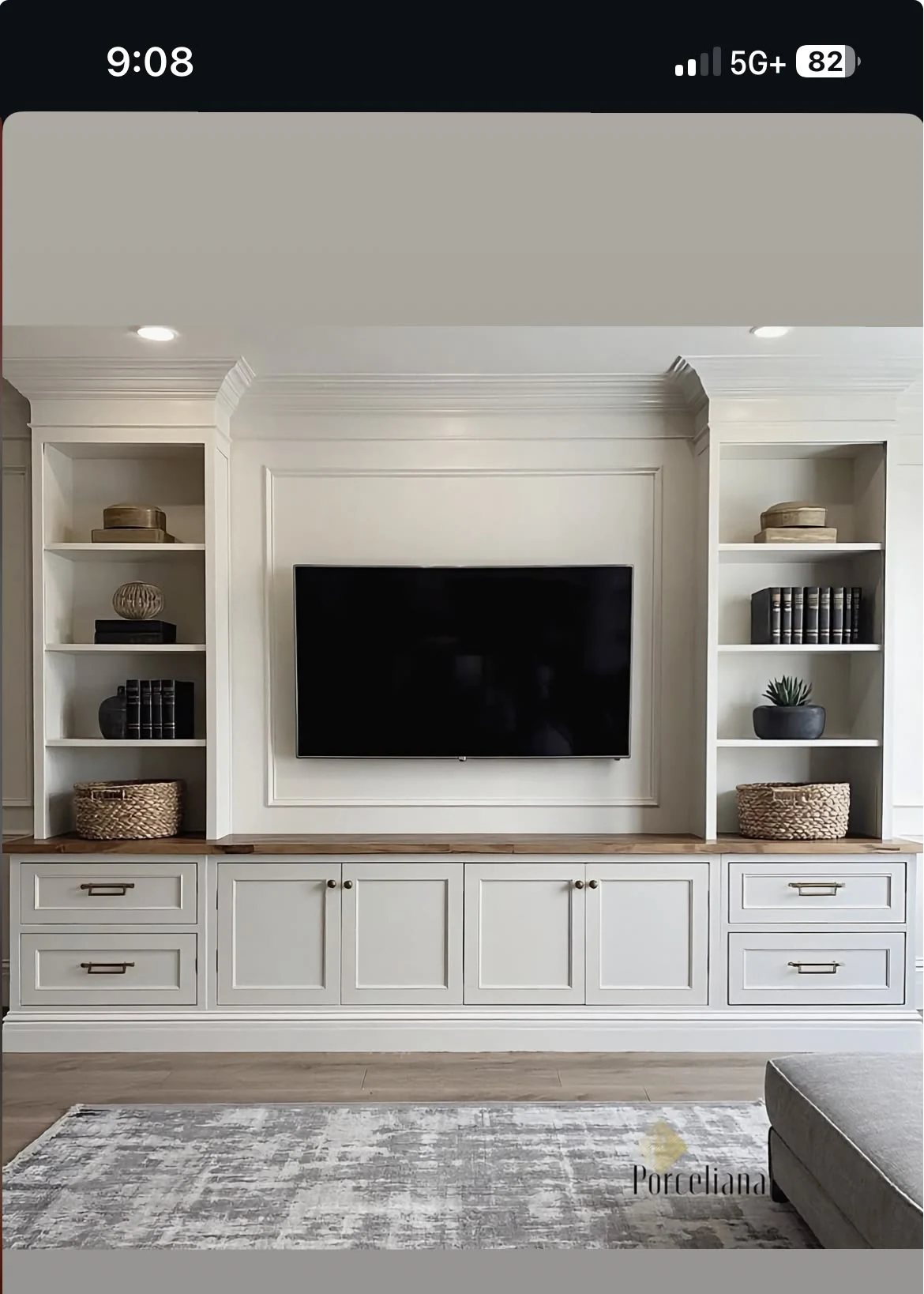 White entertainment wall with television and symmetrical shelving