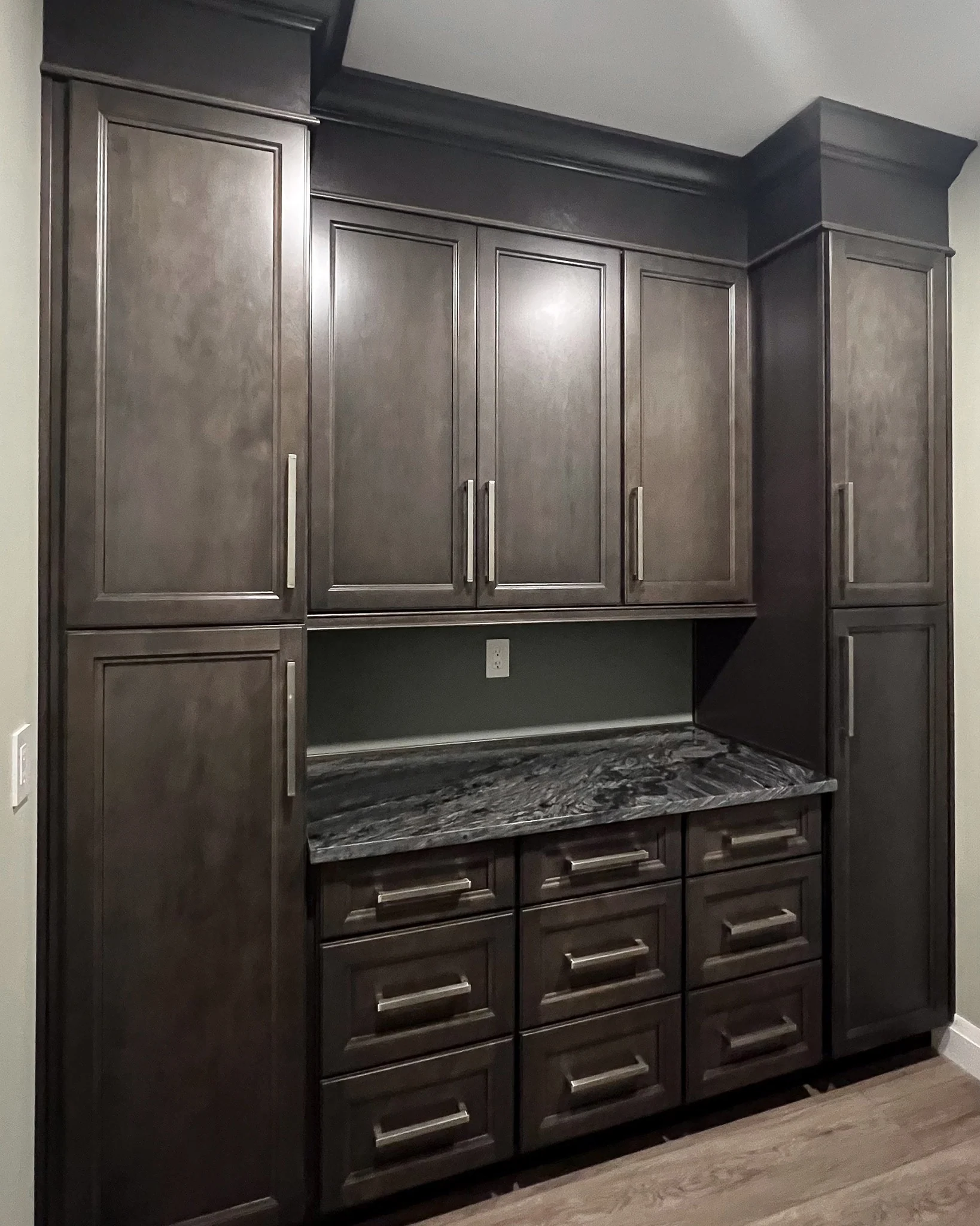 Dark wood built-in storage cabinets with drawer fronts