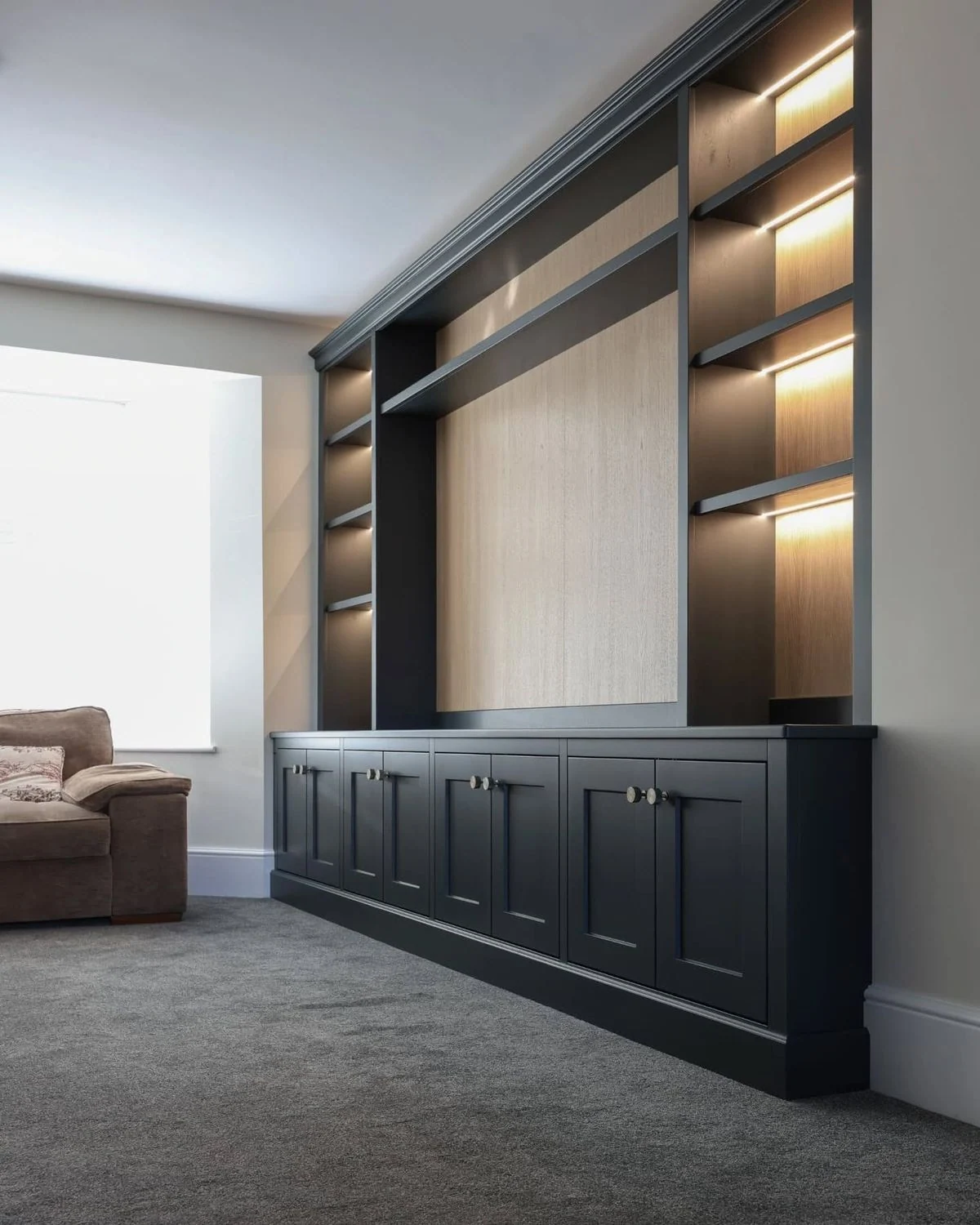 Modern dark built-in cabinetry framing display shelves