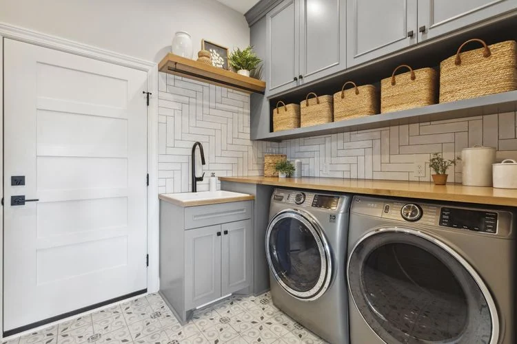Laundry room with washer, dryer and white overhead cabinets