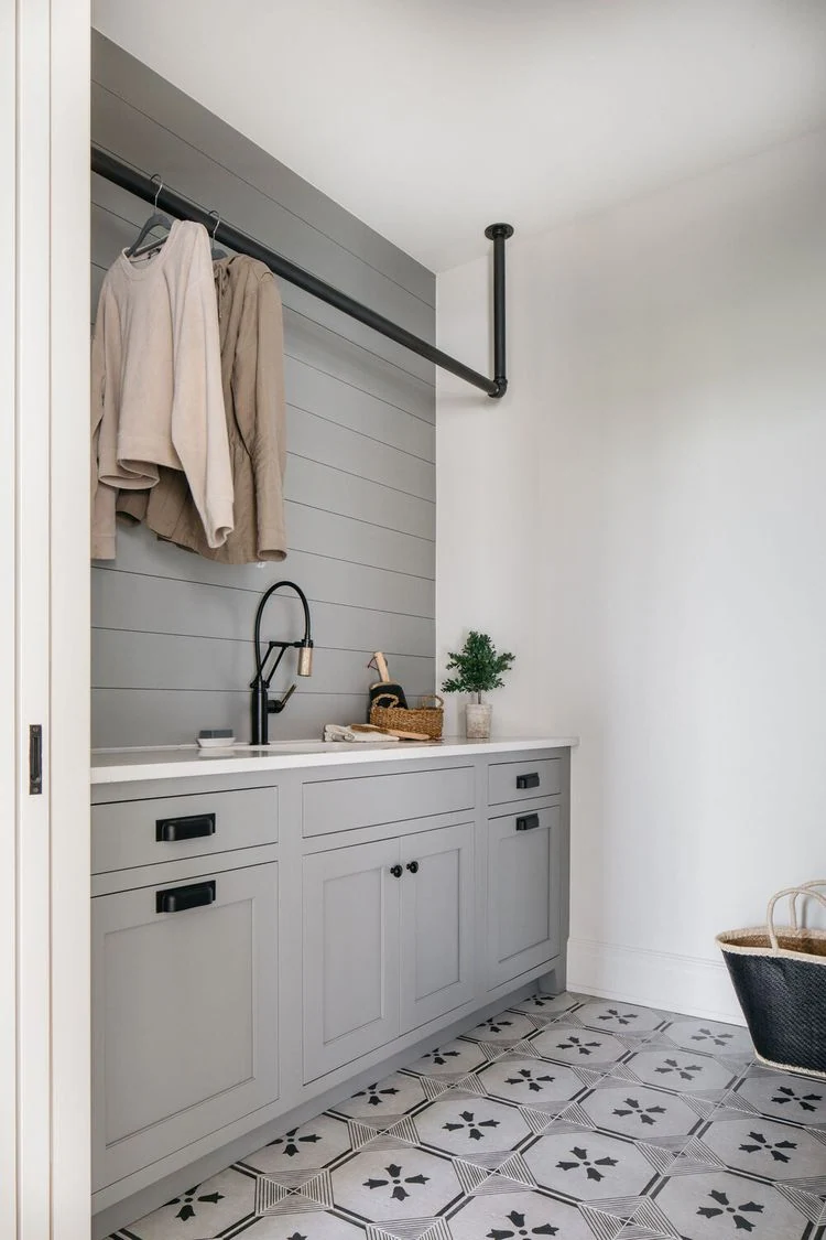 Laundry alcove with shelves and enclosed utility cabinetry
