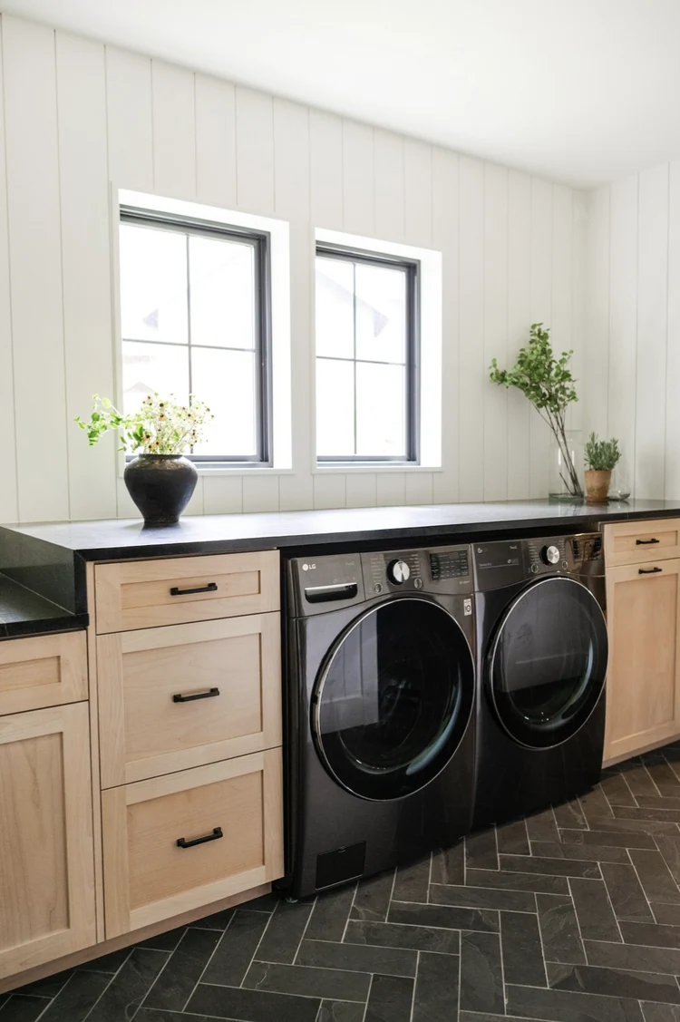 Laundry room with wood countertops and cabinets beside appliances