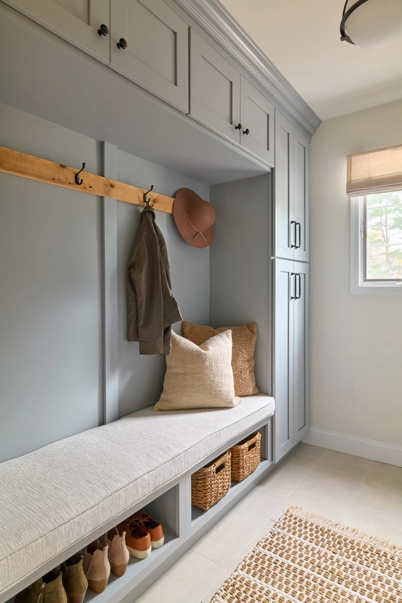 Entryway built-in bench with coat hooks and closed storage